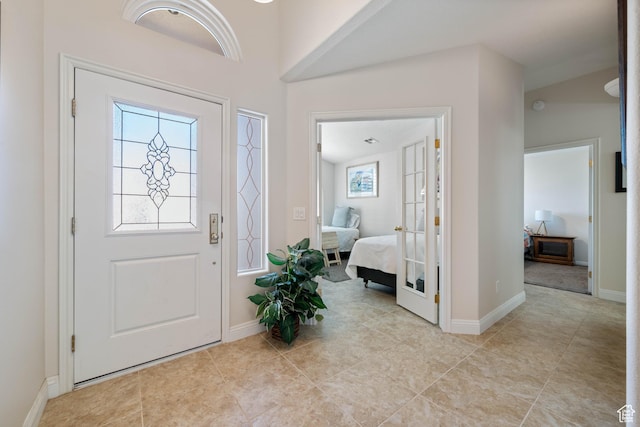 entrance foyer featuring light tile patterned floors and baseboards
