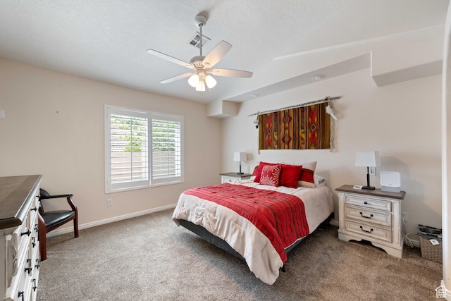carpeted bedroom featuring baseboards, ceiling fan, and a textured ceiling