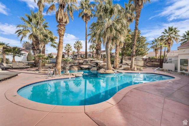 view of swimming pool with a patio area and fence