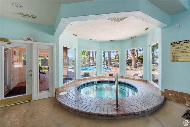 view of pool with an in-ground hot tub