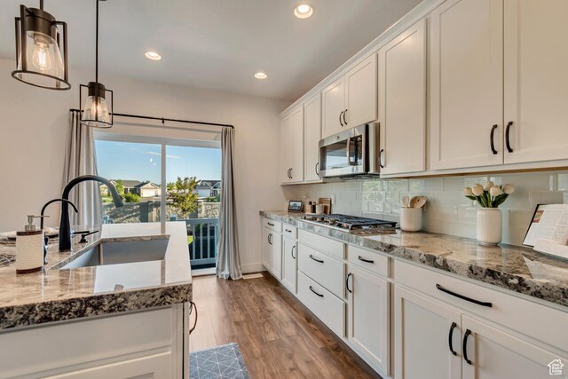 2217 W 650 S, Lehi, UT 84043 - kitchen with appliances with stainless steel finishes, a sink, white cabinetry, decorative backsplash, and light stone countertops