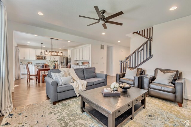2217 W 650 S, Lehi, UT 84043 - living room with a ceiling fan, recessed lighting, light wood-style floors, and stairway