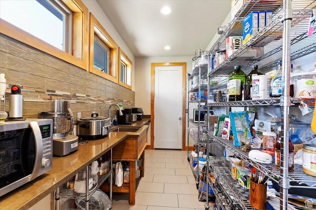 1108 N Lakeside Ct, Eden, UT 84310 - kitchen featuring a sink, stainless steel microwave, decorative backsplash, tile patterned flooring, and recessed lighting