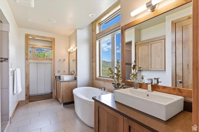 1108 N Lakeside Ct, Eden, UT 84310 - bathroom featuring a freestanding bath, tile patterned floors, and two vanities
