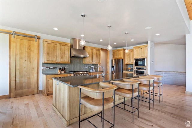 1108 N Lakeside Ct, Eden, UT 84310 - kitchen with stainless steel appliances, light wood-type flooring, dark countertops, a large island, and recessed lighting