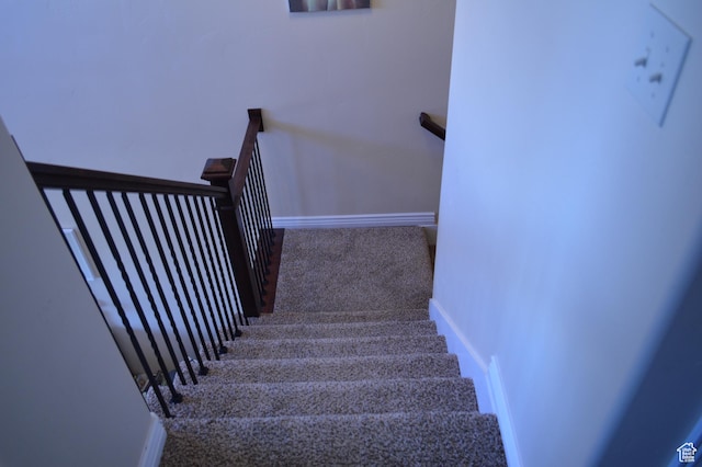 staircase with carpet flooring and baseboards