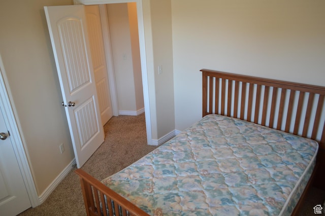 bedroom featuring carpet flooring and baseboards