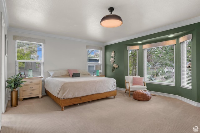 bedroom featuring crown molding, light carpet, and baseboards