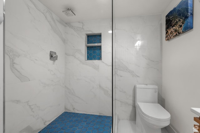 bathroom with a marble finish shower and toilet