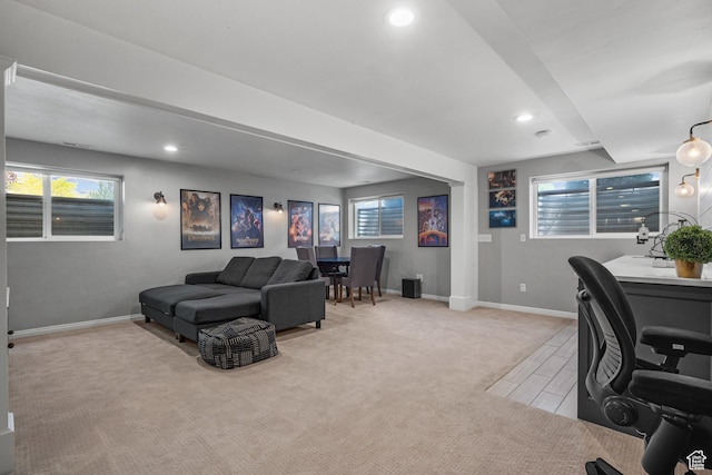 office space featuring recessed lighting, baseboards, healthy amount of natural light, and light carpet
