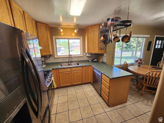 628 E 150 S, Kaysville, UT 84037 - kitchen with appliances with stainless steel finishes, a sink, a peninsula, rail lighting, and decorative backsplash