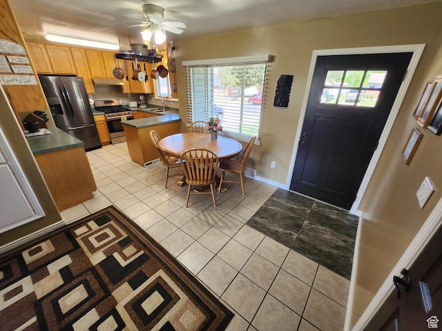 628 E 150 S, Kaysville, UT 84037 - kitchen with stainless steel appliances, light tile patterned floors, under cabinet range hood, and healthy amount of natural light