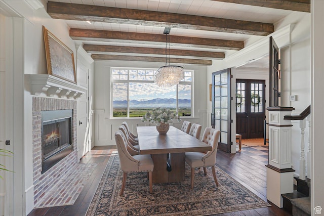 6071 W 1800 S, Mendon, UT 84325 - dining area with dark wood finished floors, a fireplace, french doors, a chandelier, and beamed ceiling