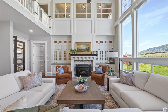 6071 W 1800 S, Mendon, UT 84325 - living area featuring healthy amount of natural light, a high ceiling, baseboards, wood finished floors, and a wood stove