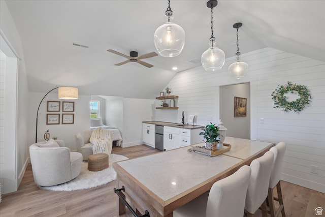 6071 W 1800 S, Mendon, UT 84325 - dining room featuring lofted ceiling, light wood finished floors, a ceiling fan, baseboards, and wooden walls