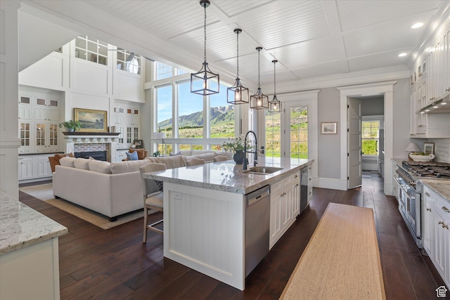 6071 W 1800 S, Mendon, UT 84325 - kitchen featuring appliances with stainless steel finishes, a sink, white cabinets, baseboards, and dark wood-style floors