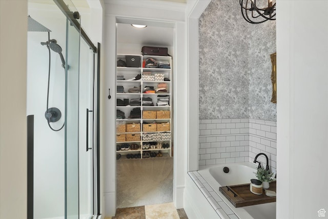 6071 W 1800 S, Mendon, UT 84325 - bathroom featuring a shower stall, a spacious closet, and a relaxing tiled tub