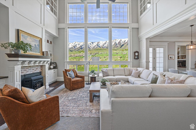 6071 W 1800 S, Mendon, UT 84325 - living area with a high ceiling, wood finished floors, ceiling fan, baseboards, and crown molding