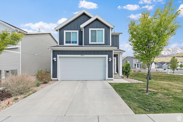 895 S Brubaker Way, Santaquin, UT 84655 - traditional-style house featuring board and batten siding, a front yard, an attached garage, concrete driveway, and a mountain view
