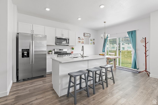 895 S Brubaker Way, Santaquin, UT 84655 - kitchen with appliances with stainless steel finishes, a sink, wood finished floors, white cabinets, and recessed lighting