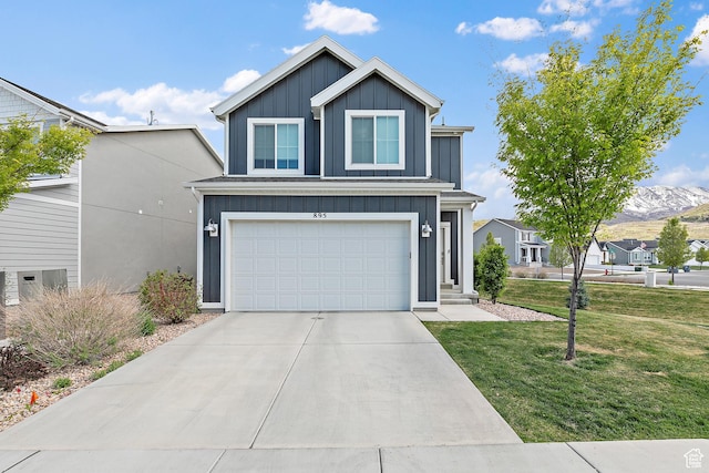 895 S Brubaker Way, Santaquin, UT 84655 - traditional-style house featuring board and batten siding, a front yard, an attached garage, driveway, and a mountain view