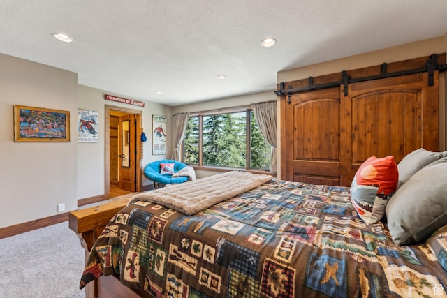3321 W Big Spruce Way Unit E54, Park City, UT 84098 - carpeted bedroom featuring baseboards, a barn door, and recessed lighting