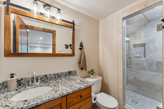 3321 W Big Spruce Way Unit E54, Park City, UT 84098 - bathroom featuring a shower stall, toilet, vanity, and a textured ceiling