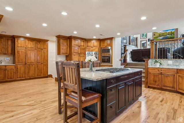 3321 W Big Spruce Way Unit E54, Park City, UT 84098 - kitchen with stainless steel appliances, light wood-style flooring, brown cabinetry, and recessed lighting