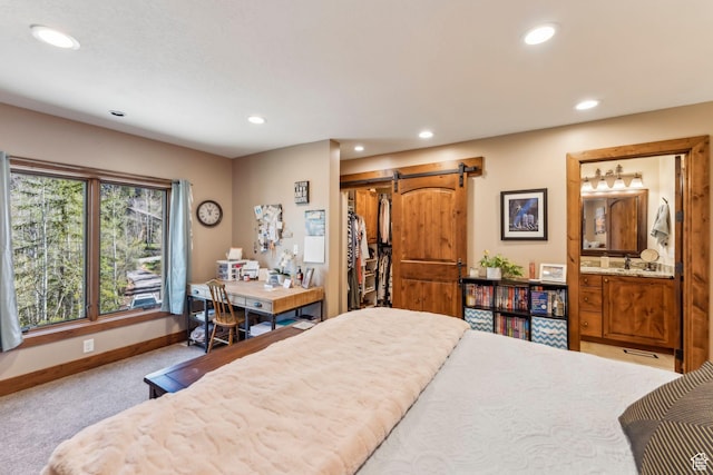 3321 W Big Spruce Way Unit E54, Park City, UT 84098 - carpeted bedroom featuring a barn door, recessed lighting, baseboards, connected bathroom, and a closet