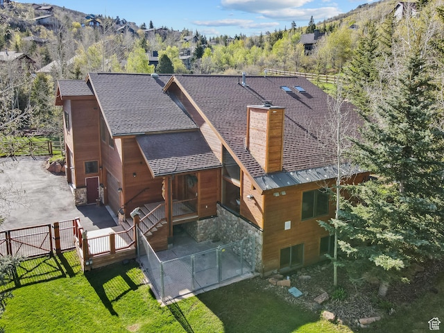 3321 W Big Spruce Way Unit E54, Park City, UT 84098 - back of property featuring a patio area, roof with shingles, and stone siding