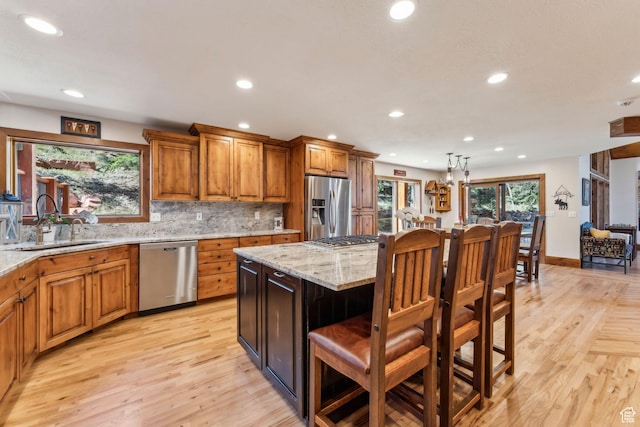 3321 W Big Spruce Way Unit E54, Park City, UT 84098 - kitchen featuring stainless steel appliances, recessed lighting, a sink, brown cabinets, and light wood finished floors
