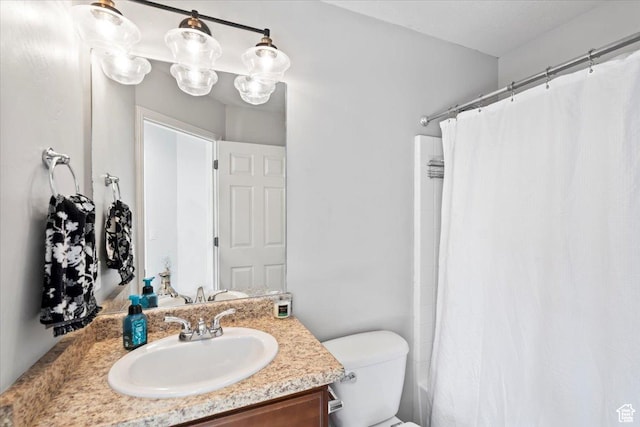 full bath featuring vanity and toilet