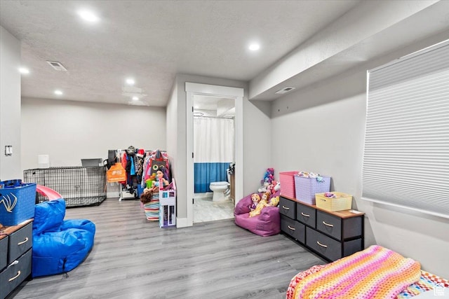 game room featuring wood finished floors, recessed lighting, and baseboards