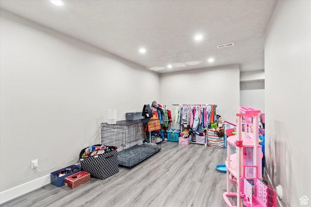 game room with wood finished floors, recessed lighting, and baseboards