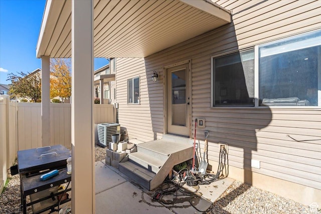 view of patio with fence, cooling unit, and area for grilling