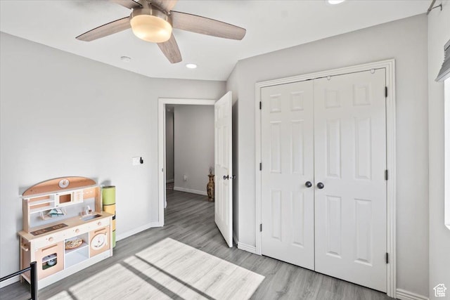 bedroom with wood finished floors, recessed lighting, baseboards, a closet, and ceiling fan