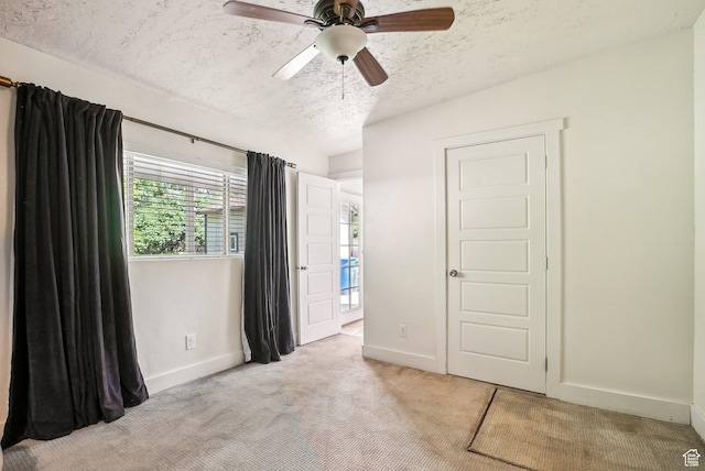 2597 S Elizabeth St, Salt Lake City, UT 84106 - unfurnished bedroom with a textured ceiling, light colored carpet, baseboards, and a ceiling fan