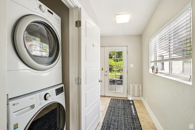 2597 S Elizabeth St, Salt Lake City, UT 84106 - washroom featuring estacked washer and dryer, light tile patterned floors, and baseboards