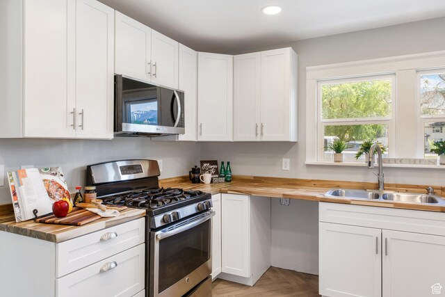 63 E 100 S, Nephi, UT 84648 - kitchen featuring appliances with stainless steel finishes, a sink, wood counters, white cabinetry, and recessed lighting