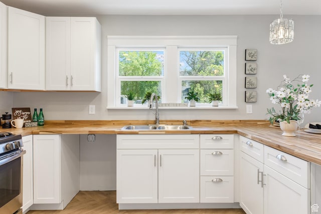 63 E 100 S, Nephi, UT 84648 - kitchen featuring wood counters, a sink, healthy amount of natural light, and stainless steel range with electric stovetop