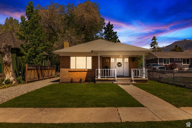 63 E 100 S, Nephi, UT 84648 - bungalow with brick siding, a porch, and a chimney