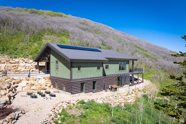 10256 N Basin Canyon Rd, Park City, UT 84098 - back of house featuring roof mounted solar panels, board and batten siding, and a mountain view