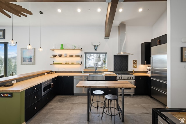 10256 N Basin Canyon Rd, Park City, UT 84098 - kitchen with high quality appliances, butcher block countertops, wall chimney range hood, dark cabinetry, and recessed lighting