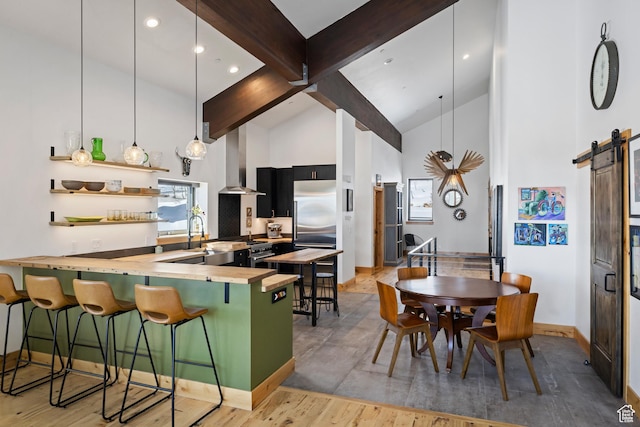 10256 N Basin Canyon Rd, Park City, UT 84098 - kitchen featuring exhaust hood, high vaulted ceiling, beam ceiling, a barn door, and baseboards