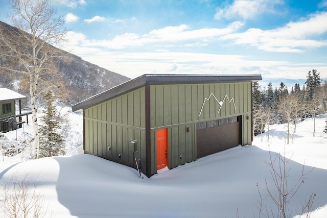 10256 N Basin Canyon Rd, Park City, UT 84098 - snow covered garage featuring a detached garage and a mountain view
