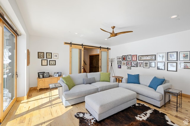 10256 N Basin Canyon Rd, Park City, UT 84098 - living room featuring a barn door, ceiling fan, light wood-style flooring, and recessed lighting