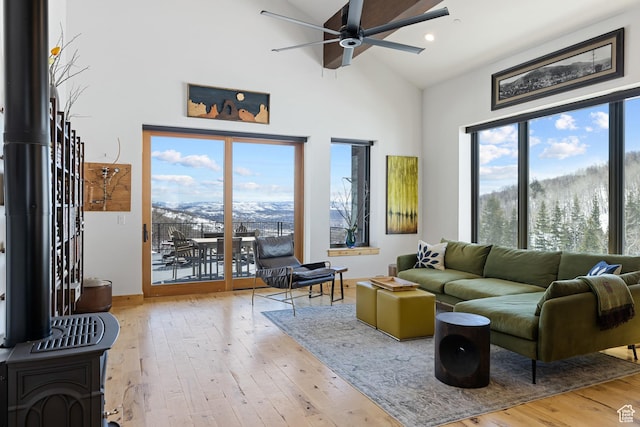 10256 N Basin Canyon Rd, Park City, UT 84098 - living area featuring a ceiling fan, wood-type flooring, a wood stove, high vaulted ceiling, and recessed lighting