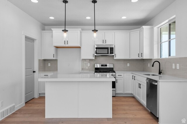 2415 N Ribe Ln, Lehi, UT 84043 - kitchen featuring appliances with stainless steel finishes, a sink, white cabinetry, recessed lighting, and light countertops