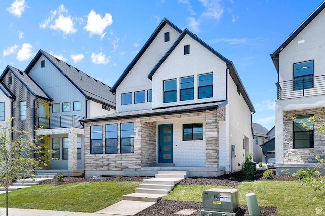 2415 N Ribe Ln, Lehi, UT 84043 - view of front of property with a front yard, stone siding, and brick siding