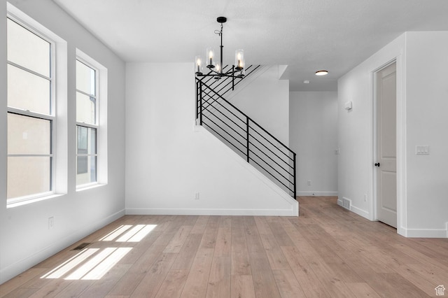 2415 N Ribe Ln, Lehi, UT 84043 - interior space with a chandelier, stairs, light wood-style floors, and baseboards